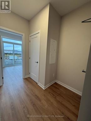 Ottawa townhouse for rent - A room with a white door and a window with a view of a balcony.