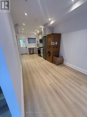 Toronto (University) apartment for rent - A room with a wooden floor and a cardboard box in it.