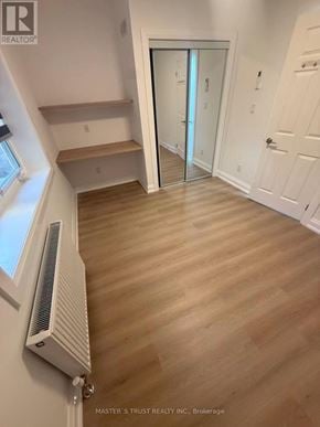Toronto (University) apartment for rent - A room with a wood floor and a window with a white frame.