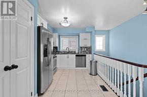 Mississauga (Erindale) townhouse for rent - A kitchen with blue walls and white cabinets.