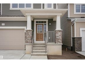 Edmonton apartment for rent - A house with a brown front door and a garage door.