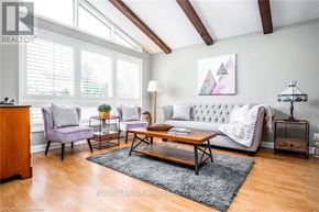 Niagara Falls (Chippawa) apartment for rent - A living room with a white sofa, a wooden coffee table, and a grey rug.