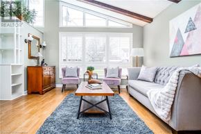 Niagara Falls (Chippawa) apartment for rent - A living room with a grey couch, a wooden coffee table, and a large window.