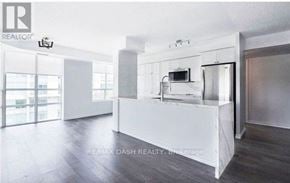 Toronto (Niagara) condo for rent - A white reception desk in a room with a glass door and a window.