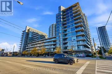 Toronto (Islington-City Centre West) condo for rent - A modern multi-story building with a car parked in front.