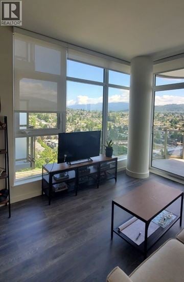 Burnaby apartment for rent - A living room with a television and a view of the city.