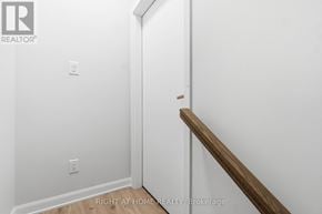 Ottawa townhouse for rent - A white wall with a wooden staircase.