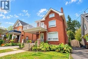 Brantford apartment for rent - A red brick house with a white roof and a balcony.