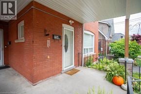 Brantford apartment for rent - A red brick house with a white door and a small porch.