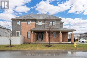 Ottawa apartment for rent - A house with a grey roof and a brick facade is for sale.
