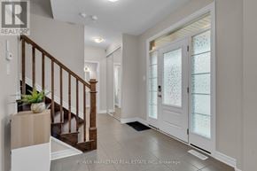 Ottawa apartment for rent - A hallway with a staircase and a glass door.