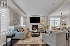 Ottawa apartment for rent - A living room with a grey couch, a black coffee table, and a flat screen TV mounted on the wall.