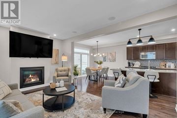 Ottawa apartment for rent - A modern living room with a fireplace and a television mounted on the wall.