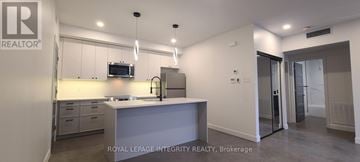 Ottawa multi-family for rent - A kitchen with a sink and a microwave.