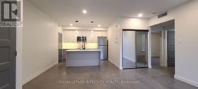 Ottawa multi-family for rent - A spacious kitchen with a refrigerator, sink, and cabinets.