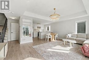 Ottawa townhouse for rent - A well-lit, spacious living room with a dining area and a staircase.