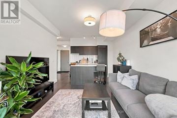 Toronto (Casa Loma) condo for rent - A living room with a grey couch and a coffee table.