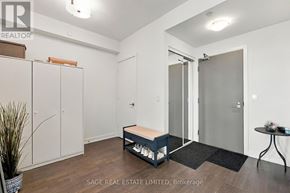 Toronto (Casa Loma) condo for rent - A real estate listing image of a bedroom with a bed, wardrobe, and a small table.