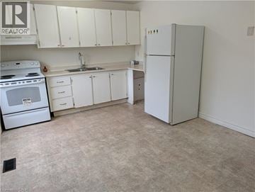 Hamilton townhouse for rent - A kitchen with white appliances and cabinets.