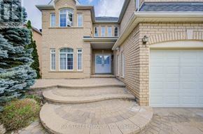 Markham (Cachet) apartment for rent - A house with a garage and a tree in front.