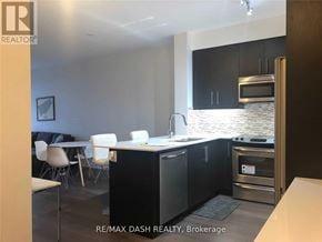 Richmond Hill (Langstaff) condo for rent - A modern kitchen with black cabinets and stainless steel appliances.