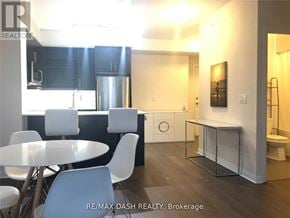 Richmond Hill (Langstaff) condo for rent - A modern kitchen with a dining table and chairs.