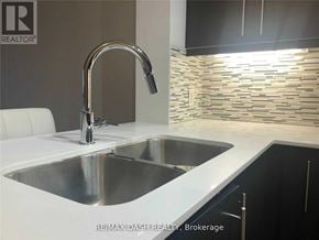 Richmond Hill (Langstaff) condo for rent - A modern kitchen with a stainless steel sink and a chrome faucet.