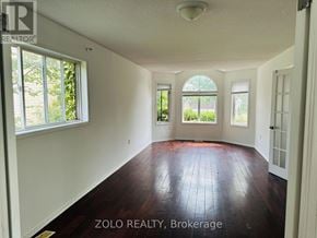 Barrie (Georgian Drive) apartment for rent - A room with white walls and wood flooring, with windows on the wall.