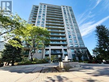 Toronto (Edenbridge-Humber Valley) condo for rent - A tall residential building with a fountain in front.