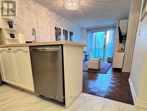 Toronto (Edenbridge-Humber Valley) condo for rent - A kitchen with a refrigerator, sink, and a window with curtains.