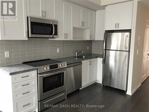 Toronto (Briar Hill-Belgravia) townhouse for rent - A kitchen with a stainless steel refrigerator, oven, and microwave.
