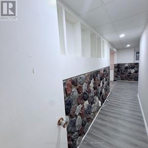 Hamilton (Vincent) apartment for rent - A hallway with a stone wall and wooden floor.