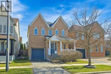 Ajax (Northeast Ajax) apartment for rent - A large brick house with a blue garage door is for sale.
