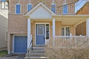 Ajax (Northeast Ajax) apartment for rent - A brick house with a blue door and windows.