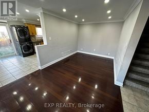 Brampton (Northwest Sandalwood Parkway) apartment for rent - A room with wooden flooring and a staircase on the right side.