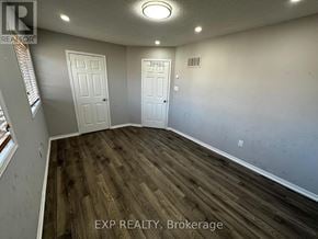 Brampton (Northwest Sandalwood Parkway) apartment for rent - A room with wooden flooring and two white doors.