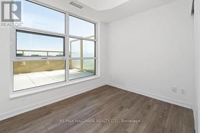 Toronto (Weston-Pellam Park) condo for rent - A room with a large window and wooden flooring.