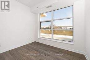 Toronto (Weston-Pellam Park) condo for rent - A room with a large window and wooden flooring.
