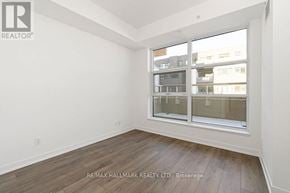 Toronto (Weston-Pellam Park) condo for rent - A room with a large window and wooden flooring.