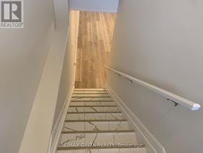 Russell apartment for rent - A staircase with wooden steps and a white handrail.