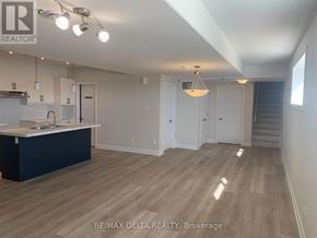 Russell apartment for rent - A spacious kitchen with white cabinets and a dark island.