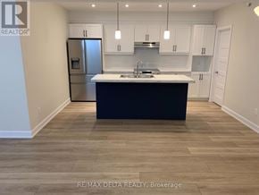 Russell apartment for rent - A kitchen with a black countertop and white cabinets.