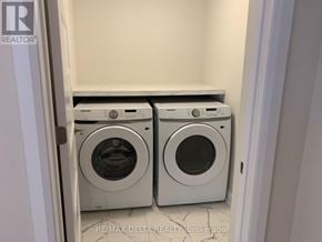 Russell apartment for rent - A pair of front loading washing machines in a laundry room.