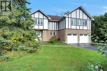 Ottawa apartment for rent - A house with a white garage door is for sale.