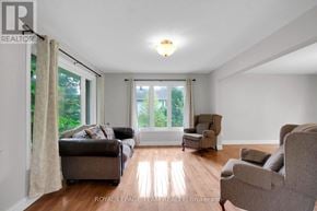Ottawa apartment for rent - A living room with a couch, chair, and sliding glass doors.