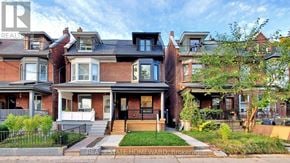 Toronto (Trinity-Bellwoods) duplex for rent - A row of houses with the first one having a sign that says REA on it.