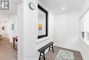 Toronto (Trinity-Bellwoods) duplex for rent - A room with a bench and a clock on the wall.