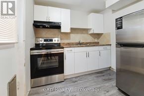 London East (East I) apartment for rent - A kitchen with a stove top oven and white cabinets.