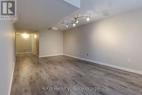 London East (East I) apartment for rent - A room with wooden flooring and a doorway leading to another room.