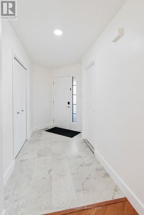 London North (North C) apartment for rent - A hallway with marble flooring and white walls.